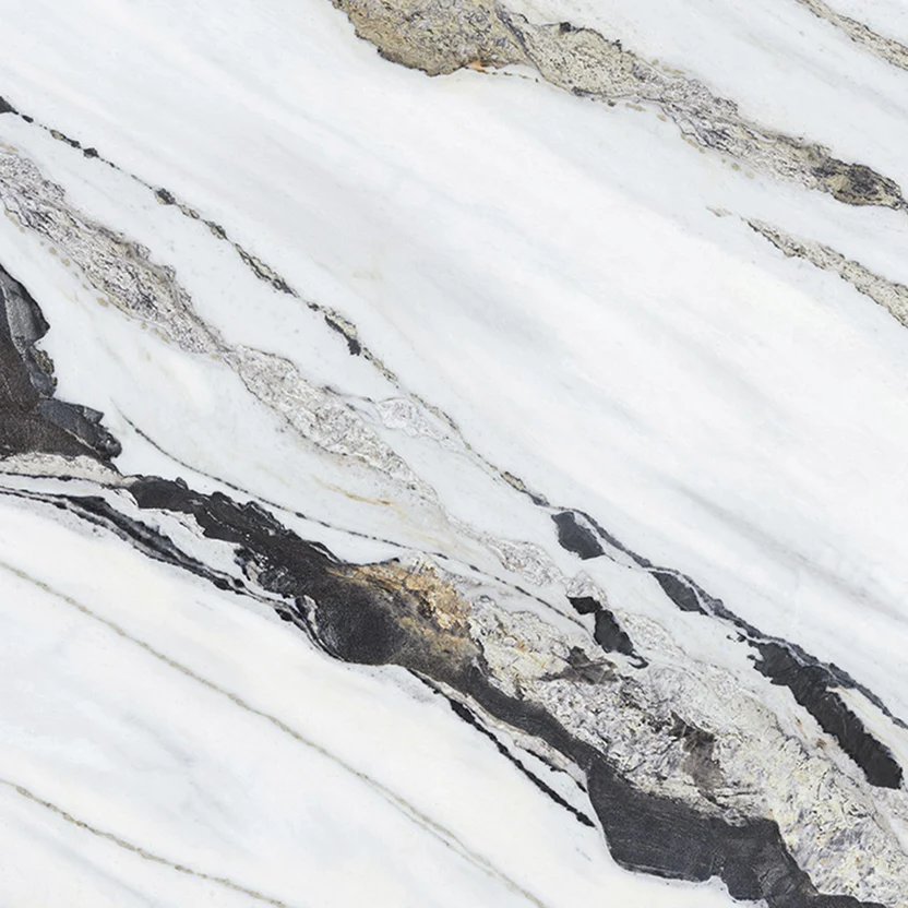 purastone-prima-dalmata Purastone Prima Dalmata, superficie sinterizada de fondo claro con vetas negras, grises y doradas, ideal para mesadas, islas, revestimientos y proyectos de interior y exterior.